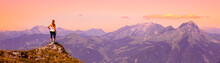 Woman Hiker On The Peak Of Mountain At Sunset