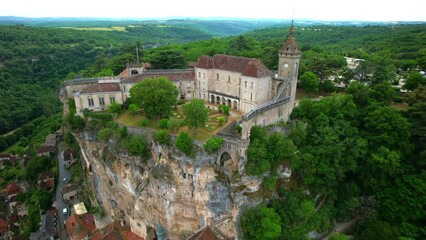 Wall Mural - Aerial shot of the famous rocamadour village in France, backward flight from the castle at the top to the general wide landscape view.