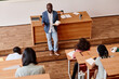 © AnnaStills - High angle view of African teacher telling lecture to students at auditorium of university