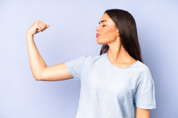 Wall Mural - hispanic pretty woman feeling happy, satisfied and powerful, flexing fit and muscular biceps, looking strong after the gym