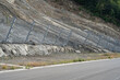 Active robust rockfall barrier system with wire mesh along the road, brake for rocks fall. Slope strengthening after landslide in Tskneti Georgia. 