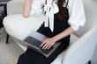 © tokyovisionaryroom - A Japanese woman typing laptop by remote work in the office faceless composition
