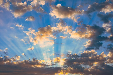 Wall Mural - Beautiful rays of light and clouds. Divine sky, glow and shadows from dark clouds.