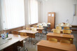© slexp880 - Empty school classroom with desks, chairs and wardrobe. Preparation for the beginning of the school year and school lessons. Selective focus.