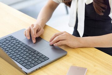 A Japanese woman typing laptop by remote work in the office faceless composition