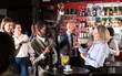 © JackF - Smiling afro man and Caucasian woman having conversation on corporate party