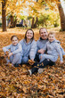 © Strelciuc - Family posing in autumn park having fun. Happy family, childhood. Parent, child. Smiling girl. Autumn forest.
