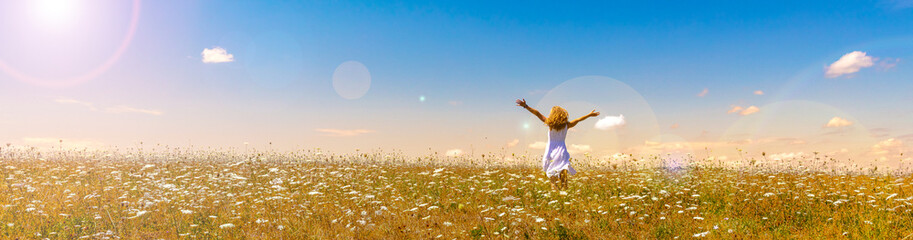 woman in a field with flowers- freedom,  active,  happiness concept