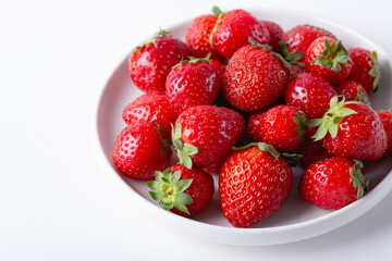 Wall Mural - Red ripe strawberry in the white bowl, light background