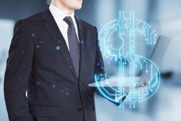Fototapete - businessman hands holding laptop with abstract glowing blue circuit dollar hologram on blurry bokeh office interior background. Online banking and financial technology concept. Double exposure.
