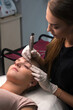 © Ludaiv - Permanent eyebrow makeup. Cosmetologist applying tattooing of eyebrows.