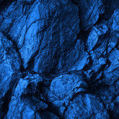 Wall Mural - rock texture. navy blue color. toned rough mountain surface with cracks. close-up. stone granite bac