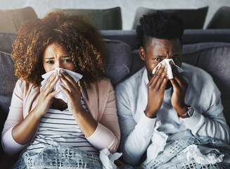 Wall Mural - portrait of a sick couple suffering from the flu, corona or sinus at home together, feeling unwell a