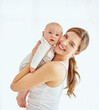© Cecilie S W/peopleimages.com - Portrait of a happy young mother hugging her cute baby boy at home, bonding and enjoying parenthood. Single parent being playful and affectionate, embracing precious moments with her new born child
