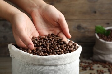 Sticker - Woman taking roasted coffee beans from bag, closeup