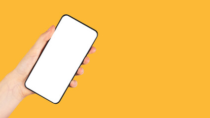 Poster - Banner with hand holding phone mockup in rotated position on orange background. Telephone template with blank screen. Space for text. High quality photo