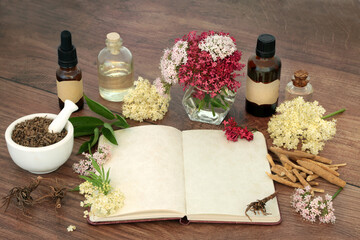 Wall Mural - Stress reducing herbal plant medicine with valerian root, ashwagandha and elder flowers and notebook for formulas. For stress reducing natural flower remedies. On rustic wood.