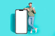 Leinwandbild Motiv Photo of influencer blogger man hold telephone read message empty space wear pullover jeans isolated blue color background