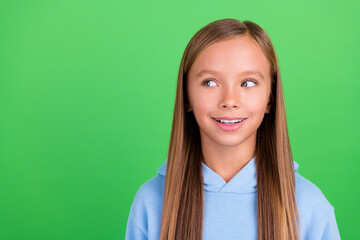 Sticker - Close up photo of lovely pretty small girl wondered look empty space wear trendy blue sport clothes isolated on green color background