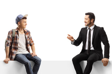 Wall Mural - Businessman talking to a male student seated on a blank panel