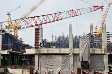 Wall Mural - Asian labor people and thai labour workers use machine and heavy machinery working builder new building tower at construction site high-rise building on scaffold at capital city in Bangkok, Thailand