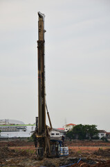 Wall Mural - Asian labor people and thai labour workers use machine and heavy machinery working builder building tower at construction site building on scaffold at capital city on July 15, 2016 in Bangkok Thailand