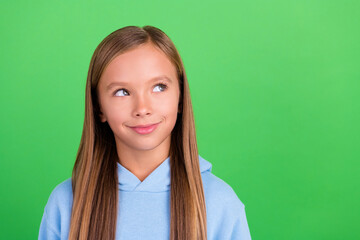 Canvas Print - Close up photo of charming pupil girl look empty space curious new offer wear trendy blue sport outfit isolated on green color background