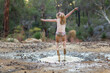 © Austockphoto - Young kid in undies splashing in muddy puddle