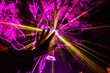 © Austockphoto - Rays of light from festival display shine through mans hand