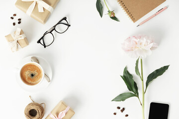 Wall Mural - festive arrangement: gift boxes, coffee, notebook, mobile phone, glasses and flowers on a white tabl