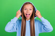 Photo portrait of funky naughty little girl hands touch hood tongue out dressed trendy blue sweatshirt isolated on green color background