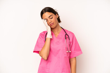 Wall Mural - pretty hispanic woman feeling bored, frustrated and sleepy after a tiresome. veterinarian concept