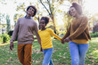 © Mediteraneo - Happy family mother father and daughter on autumn walk in the park
