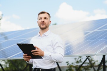 Engineer at solar power station with solar panel. Practical lessons on renewable energy power plants.