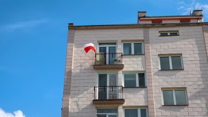 Wall Mural - Polish flag on apartment building in Warsaw city, Poland, 4k