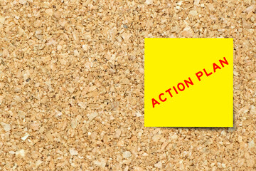 Canvas Print - Yellow note paper with word action plan on cork board background with copy space