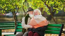 Amazing Looking Old Woman In The Middle Of The Park Together With A Old Man Speeding Time Together While Take A Sit On The Park And Hugging Each Other