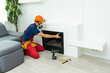 © Angelov - Service technician working on a fireplace inside of a residential home