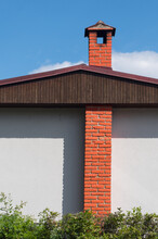 Red Chimney On A White Wall. An Interesting Detail In Modern Architecture.