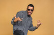 © denis_vermenko - Portrait of a cheerful smiling young african american black dancing man standing isolated over beige background.