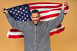 © denis_vermenko - Portrait of positive african american black guy holding usa flag, isolated over beige background.