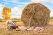 Picnic in nature in a field near a round haystack, photo zone decoration