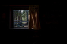 Looking Through The Window From Inside Log Cabin View Of Wooden Fence With Plenty Of Copy-space