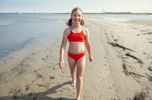 Beautiful Teen Girl Walking On Beach At Sea At Summer Holidays