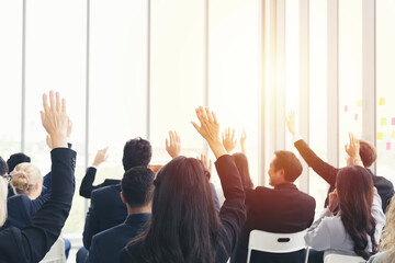 Business people raise hand to the air to speaker at Business Conference. Business people meeting at business conference room