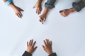 Poster - Business people writing on white paper in meeting, planning a marketing strategy and writing creative ideas together from above. Top view of hands of team of designers drawing a design on blank page