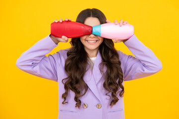 Canvas Print - Teenage girl with shampoos conditioners or shower gel. Kids hair care cosmetic product, shampoo bottle. Happy teenager, positive and smiling emotions of teen girl.