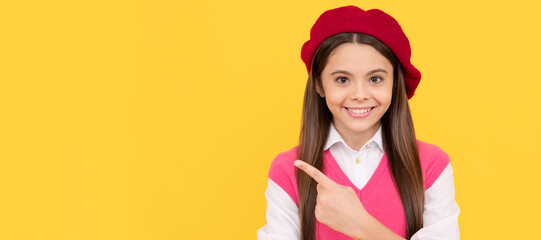 Poster - teenage beauty. tween and youth. casual fashion. happy french teen girl pointing finger. Child face, horizontal poster, teenager girl isolated portrait, banner with copy space.