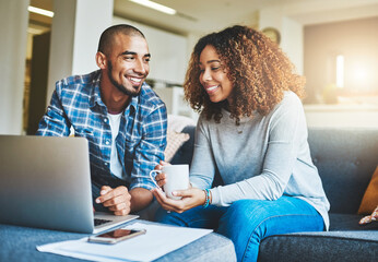 Canvas Print - Home finance, savings and investment with a young couple working on a laptop in their living room. Man and woman calculating a household budget together while relaxing and drinking coffee on the sofa