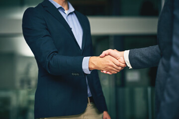 Poster - Closeup of businesswomen shaking hands during a meeting in an office. Colleagues finalizing a successful promotion, deal and merger. Coworkers greet, collaborate and negotiate during job interview